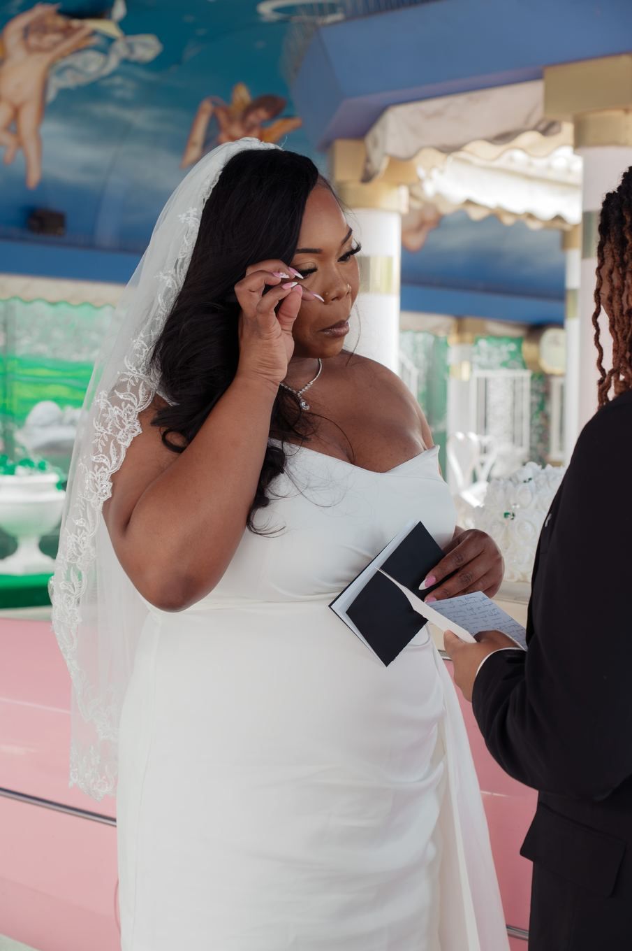 Bride wiping a tear during the vows