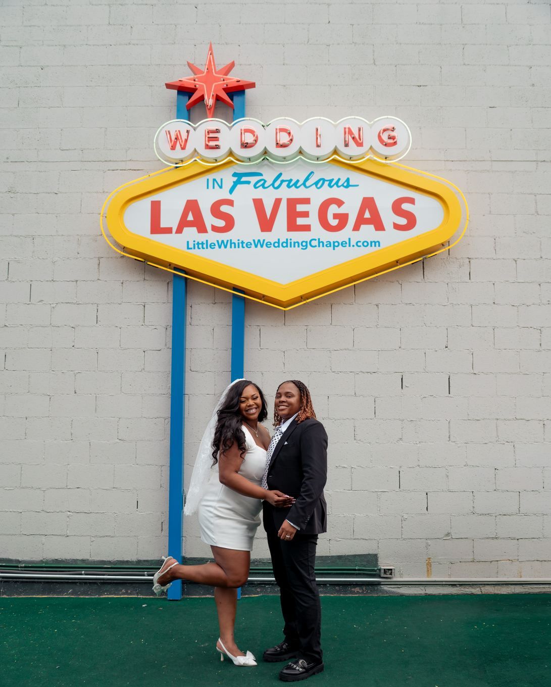 Couple beneath the Wedding in Fabulous Las Vegas sign