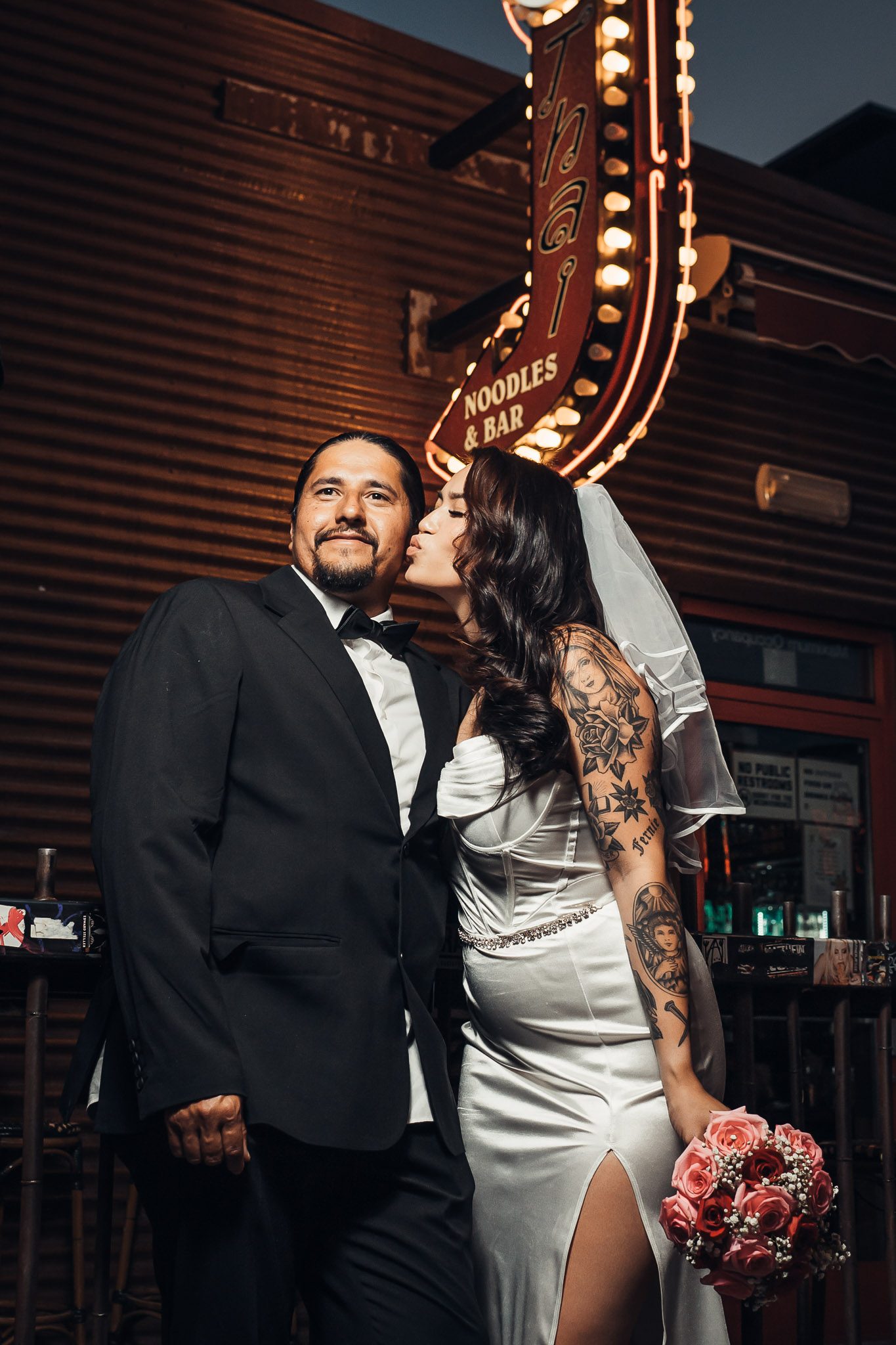 Bride and groom beneath the Fremont Street neon, Las Vegas