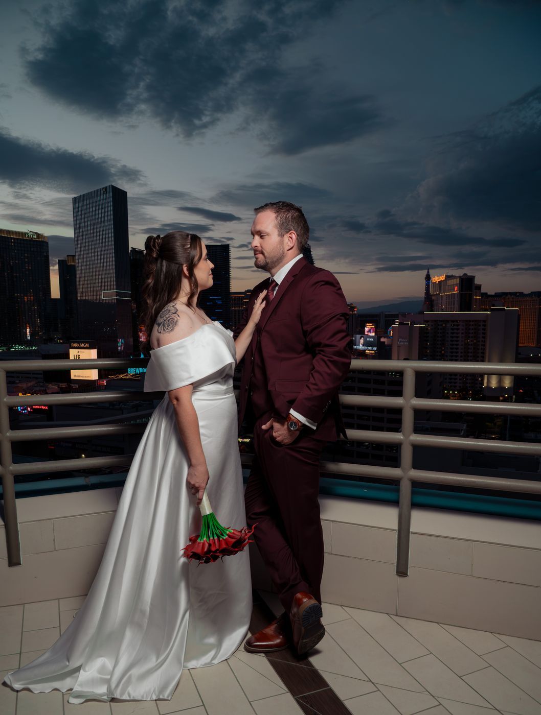 Bride and groom at dusk with the Strip skyline behind them