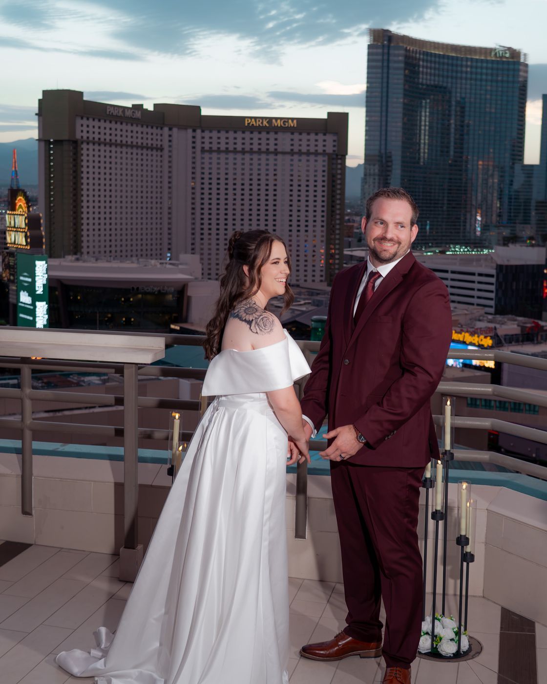 Bride and groom smiling together with the Strip behind them